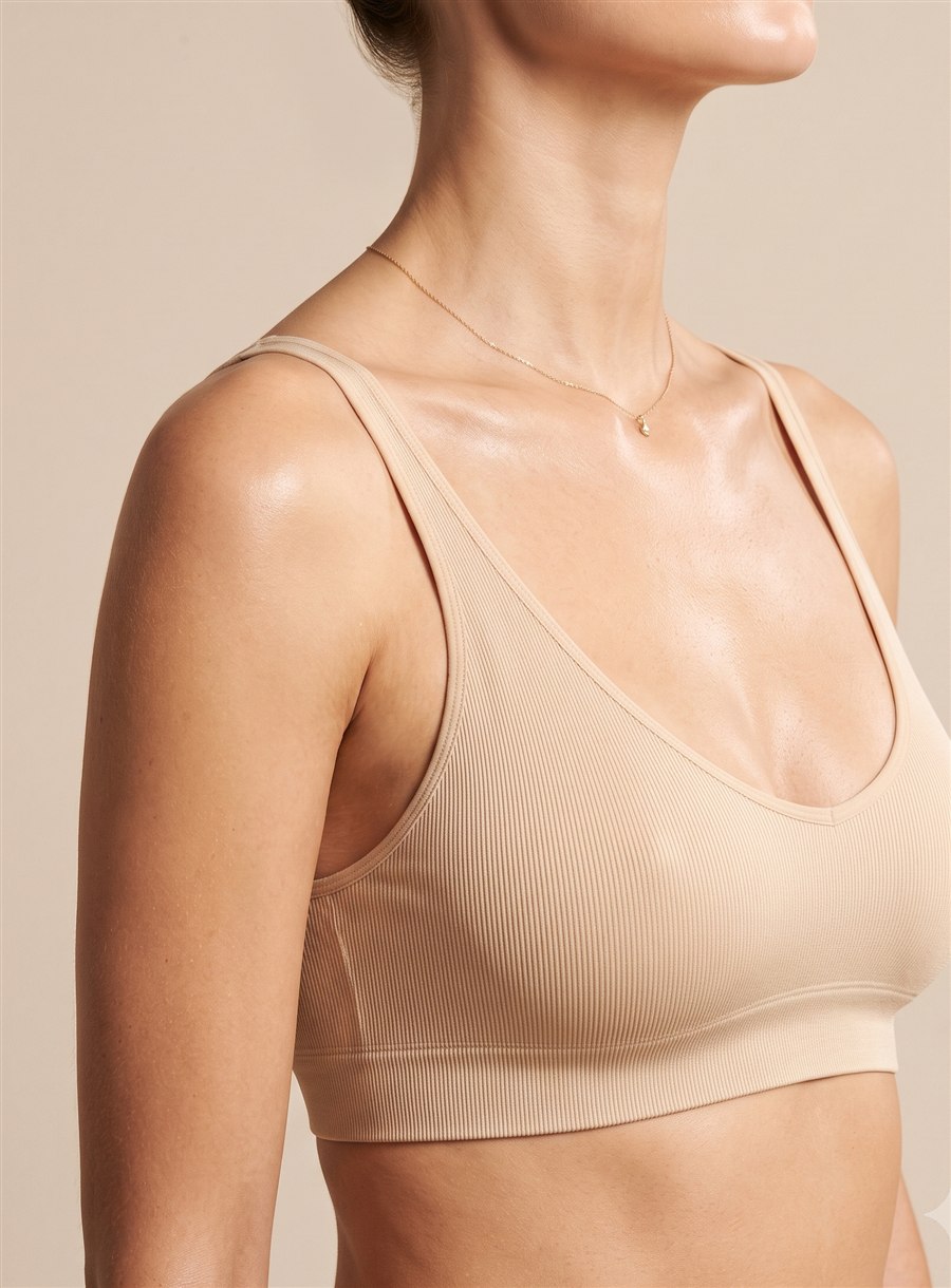 Elegant female bust in a soft neutral bralette — breast augmentation by Dr. Paulo Michels, Abu Dhabi